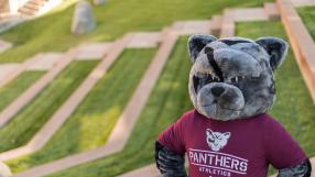 PCC Panther standing in front of amphitheater