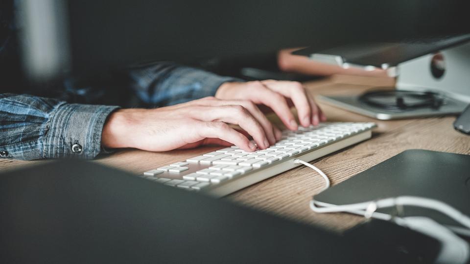 hands typing on keyboard