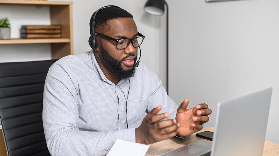 IT Helpdesk card - male at computer with headset
