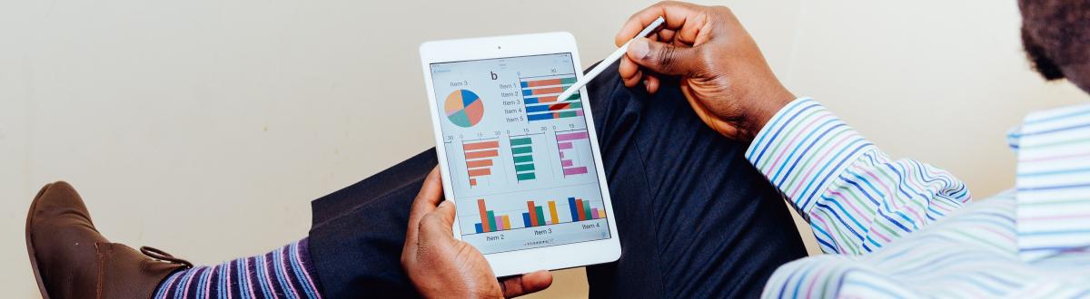 Nice dressed man looking at a tablet